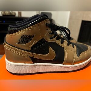 Black and Gold Jordan 1s.